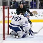 
              Toronto Maple Leafs goaltender Joseph Woll (60) blocks a shot by San Jose Sharks right wing Timo Meier, top, during the first period of an NHL hockey game Friday, Nov. 26, 2021, in San Jose, Calif. (AP Photo/Tony Avelar)
            