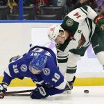 
              Minnesota Wild center Joel Eriksson Ek (14) takes down Tampa Bay Lightning right wing Corey Perry (10) during the second period of an NHL hockey game Sunday, Nov. 21, 2021, in Tampa, Fla. (AP Photo/Chris O'Meara)
            
