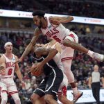 
              Chicago Bulls' Derrick Jones Jr. (5) gets airborne on a head fake by Brooklyn Nets' LaMarcus Aldridge during the first half of an NBA basketball game Monday, Nov. 8, 2021, in Chicago. (AP Photo/Charles Rex Arbogast)
            