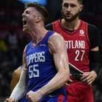 
              Los Angeles Clippers center Isaiah Hartenstein (55) celebrates after scoring during the second half of an NBA basketball game in Los Angeles, Tuesday, Nov. 9, 2021. Portland Trail Blazers center Jusuf Nurkic (27) is at right. (AP Photo/Ashley Landis)
            