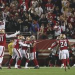 
              San Francisco 49ers free safety Jimmie Ward, third from bottom left, is congratulated by teammates after returning an interception for a touchdown against the Los Angeles Rams during the first half of an NFL football game in Santa Clara, Calif., Monday, Nov. 15, 2021. (AP Photo/Jed Jacobsohn)
            