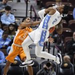 
              Tennessee's Zakai Zeigler (5) reaches for the ball as North Carolina's Caleb Love (2) drives to the basket in the first half of an NCAA college basketball game, Sunday, Nov. 21, 2021, in Uncasville, Conn. (AP Photo/Jessica Hill)
            