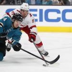 
              Carolina Hurricanes defenseman Tony DeAngelo (77) vies for the puck against the San Jose Sharks left wing Alexander Barabanov (94) during the first period of an NHL hockey game Monday, Nov. 22, 2021, in San Jose, Calif. (AP Photo/Josie Lepe)
            