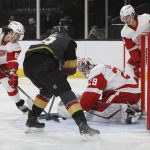 
              Detroit Red Wings goaltender Thomas Greiss (29) covers up the puck against Vegas Golden Knights right wing Reilly Smith (19) during the second period of an NHL hockey game Thursday, Nov. 18, 2021, in Las Vegas. (AP Photo/Joe Buglewicz)
            