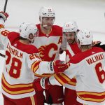 
              Calgary Flames' Johnny Gaudreau (13) celebrates his goal with Elias Lindholm (28), Matthew Tkachuk (19) and Juuso Valimaki (6) during the first period of an NHL hockey game against the Boston Bruins, Sunday, Nov. 21, 2021, in Boston. (AP Photo/Michael Dwyer)
            
