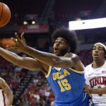 
              UCLA center Myles Johnson (15) loses control of the ball while UNLV forward Donovan Williams, right, defends during the first half of an NCAA college basketball game Saturday, Nov. 27, 2021, in Las Vegas. (Ellen Schmidt/Las Vegas Review-Journal via AP)
            