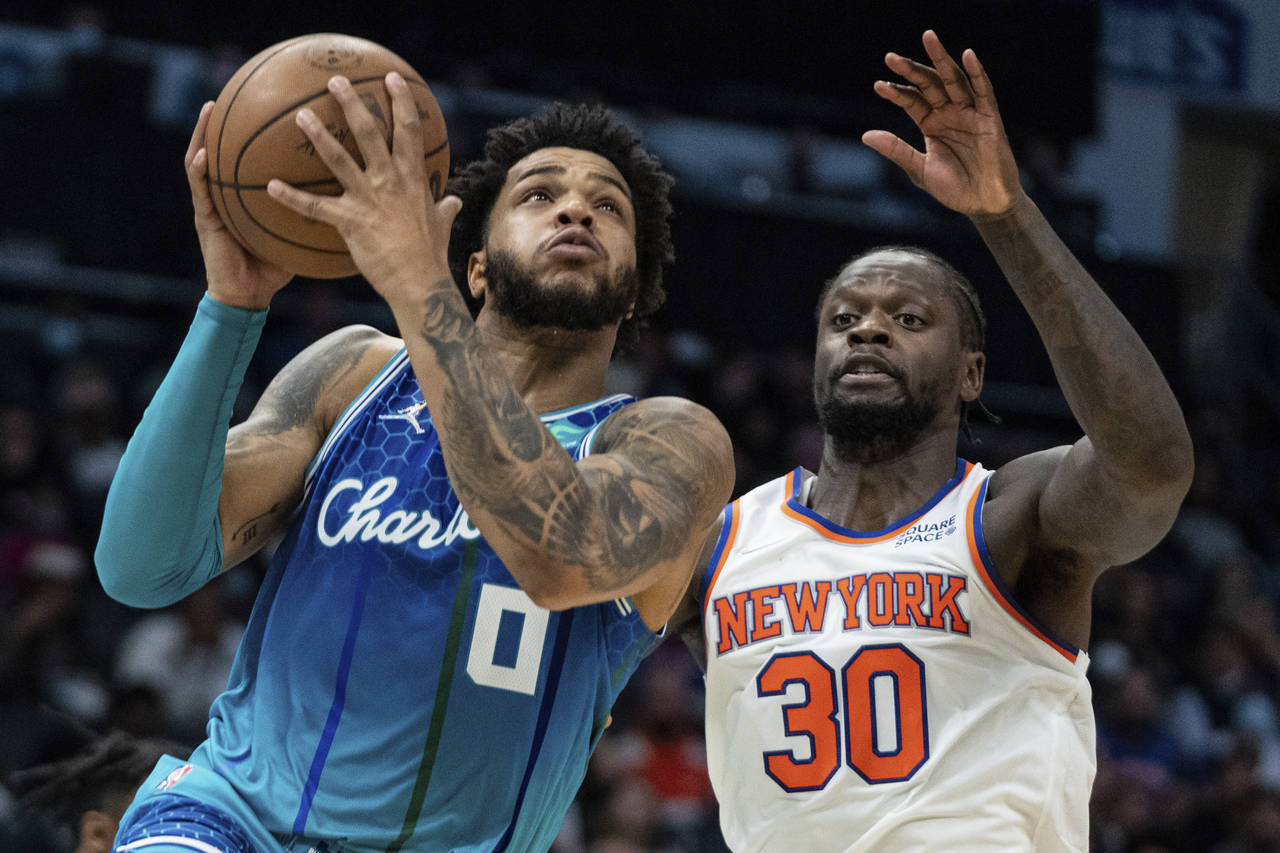 Charlotte Hornets forward Miles Bridges (0) drives to the basket past New York Knicks forward Juliu...
