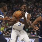 
              Orlando Magic's Mo Bamba (5) tries grab a rebound ball against Minnesota Timberwolves' Anthony Edwards (1) and Josh Okogie (20) during the first half of an NBA basketball game Monday, Nov. 1, 2021, in Minneapolis. (AP Photo/Stacy Bengs)
            