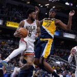 
              New Orleans Pelicans guard Nickeil Alexander-Walker (6) makes a pass around Indiana Pacers center Myles Turner (33) during the second half of an NBA basketball game in Indianapolis, Saturday, Nov. 20, 2021. The Pacers defeated the Pelicans 111-94. (AP Photo/Michael Conroy)
            