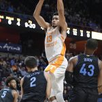 
              Tennessee's Olivier Nkamhoua (13) is called for charging as Villanova's Collin Gillespie (2) defends in the first half of an NCAA college basketball game, Saturday, Nov. 20, 2021, in Uncasville, Conn. (AP Photo/Jessica Hill)
            