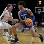
              Memphis' Lester Quinones (11) drives past Virginia Tech's Storm Murphy during the first half of an NCAA college basketball game in the NIT Season Tip-Off tournament Wednesday, Nov. 24, 2021, in New York. (AP Photo/Adam Hunger)
            
