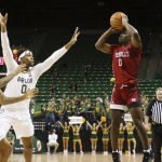 
              Nicholls State guard Ty Gordon sets up a three-point shot over Baylor forward Flo Thamba (0) in the first half of an NCAA college basketball game, Monday, Nov. 15, 2021, in Waco, Texas. (AP Photo/Rod Aydelotte)
            