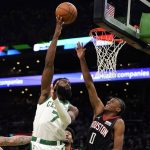 
              Boston Celtics guard Jaylen Brown (7) tips the ball toward the basket against Houston Rockets guard Jalen Green (0) during the first half of an NBA basketball game, Monday, Nov. 22, 2021, in Boston. Rockets center Daniel Theis, left, looks on. (AP Photo/Charles Krupa)
            