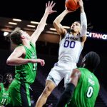 
              Kansas State guard Mike McGuirl (00)goes up to shoot over North Dakota forward Mitchell Sueker, left, and guard Caleb Nero (0) during the second half of an NCAA college basketball game on Sunday, Nov. 28, 2021, in Manhattan, Kan. (AP Photo/Nick Krug)
            