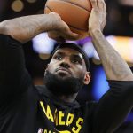 
              Los Angeles Lakers' LeBron James warms up before an NBA basketball game against the Boston Celtics, Friday, Nov. 19, 2021, in Boston. (AP Photo/Michael Dwyer)
            