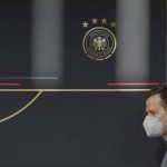 
              DFB director Oliver Bierhoff arrives at a press conference wearing mouth-nose protection in Wolfsburg, Germany, prior the World Cup qualifying match against Liechtenstein, Tuesday, Nov. 9, 2021. There is said to be a positive Corona case in the national football team circle. National coach Hansi Flick cancelled the planned training in the morning at the stadium in Wolfsburg. Five players have to be quarantined in Wolfsburg. (Swen Pfoertner/dpa via AP)
            