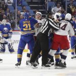 
              Linesman Scott Cherry (50) breaks up a scrum of players during the second period of an NHL hockey game between the Buffalo Sabres and the Columbus Blue Jackets, Monday, Nov. 22, 2021, in Buffalo, N.Y. (AP Photo/Joshua Bessex)
            