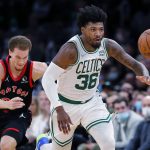 
              Boston Celtics' Marcus Smart (36) chases a loose ball in front of Toronto Raptors' Malachi Flynn during the first half of an NBA basketball game Wednesday, Nov. 10, 2021, in Boston. (AP Photo/Michael Dwyer)
            
