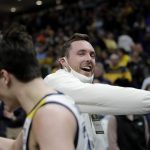 
              Marquette's Tyler Kolek, front, is congratulated by Milwaukee Bucks' Pat Connaughton after Marquette's 67-66 win over Illinois in an NCAA college basketball game Monday, Nov. 15, 2021, in Milwaukee. (AP Photo/Aaron Gash)
            
