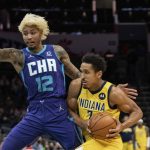 
              Indiana Pacers guard Malcolm Brogdon (7) drives to the basket while guarded by Charlotte Hornets guard Kelly Oubre Jr. (12) during the first half of an NBA basketball game in Charlotte, N.C., Friday, Nov. 19, 2021. (AP Photo/Jacob Kupferman)
            