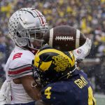 
              Michigan defensive back Vincent Gray (4) breaks up a pass intended for Ohio State wide receiver Chris Olave (2) during the first half of an NCAA college football game, Saturday, Nov. 27, 2021, in Ann Arbor, Mich. (AP Photo/Carlos Osorio)
            