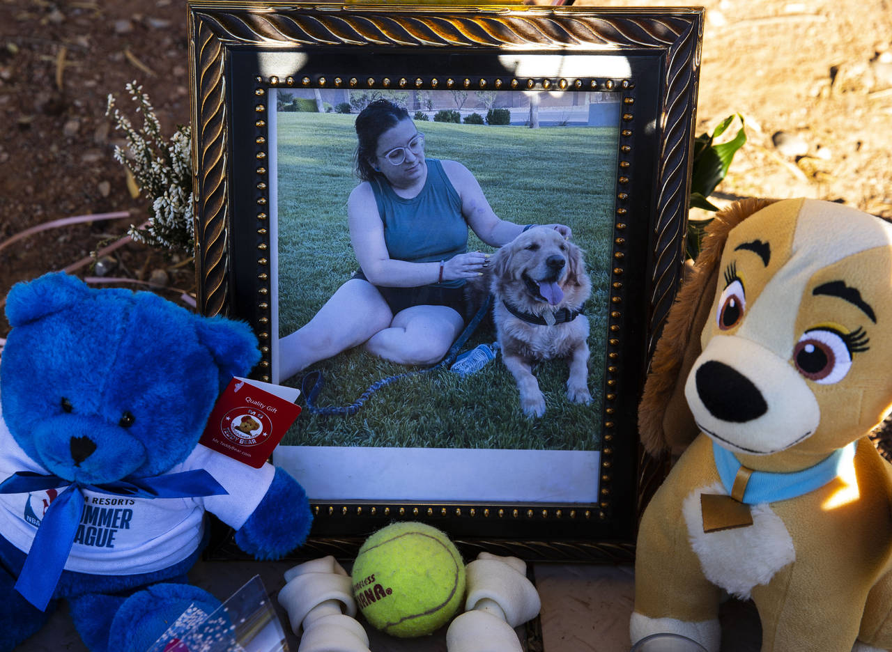 A photography of Tina Tintor, 23, and her dog is placed at a makeshift memorial site to honor them ...