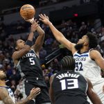 
              Sacramento Kings guard De'Aaron Fox (5) shoots over Minnesota Timberwolves center Karl-Anthony Towns as Kings center Tristan Thompson (13) and Timberwolves guard D'Angelo Russell, left, watch during the second half of an NBA basketball game Wednesday, Nov. 17, 2021, in Minneapolis. (AP Photo/Craig Lassig)
            