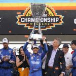 
              Kyle Larson, center, celebrates after winning a NASCAR Cup Series auto race and championship on Sunday, Nov. 7, 2021, in Avondale, Ariz. (AP Photo/Rick Scuteri)
            