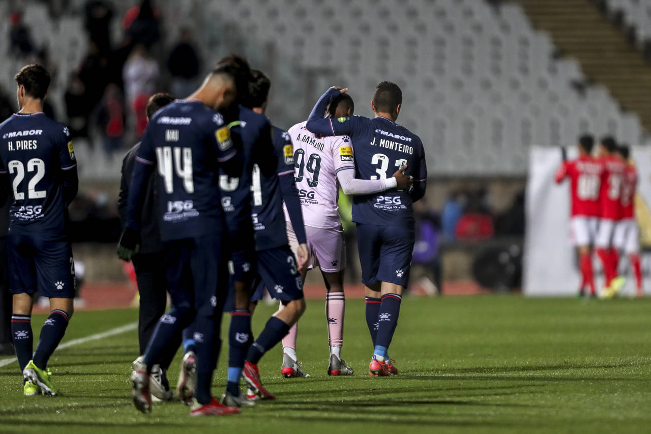 Belenenses' Joao Monteiro, center right, a goalkeeper who had to start as a field player, leaves th...