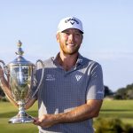 
              Talor Gooch holds the championship trophy after the final round of the RSM Classic golf tournament, Sunday, Nov. 21, 2021, in St. Simons Island, Ga. (AP Photo/Stephen B. Morton)
            