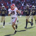 
              Georgia tight end Brock Bowers looks over his shoulder at Georgia Tech defenders as he heads to the end zone for a touchdown reception during the second quarter of an NCAA college football game on Saturday, Nov. 27, 2021, in Atlanta. (Curtis Compton/Atlanta Journal-Constitution via AP)
            
