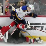 
              St. Louis Blues defenseman Torey Krug, top, battles for the puck against Chicago Blackhawks left wing Dominik Kubalik during the third period of an NHL hockey game in Chicago, Friday, Nov. 26, 2021. The Chicago Blackhawks won 3-2 in overtime.(AP Photo/Nam Y. Huh)
            