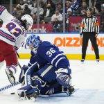 
              Toronto Maple Leafs goaltender Jack Campbell (36) makes a save against New York Rangers forward Mika Zibanejad (93) during first-period NHL hockey action in Toronto, Thursday, Nov. 18, 2021. (Nathan Denette/The Canadian Press via AP)
            