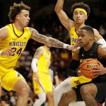 
              Minnesota guard Sean Sutherlin (24) defends against Purdue Fort Wayne guard Jalon Pipkins (50) with Minnesota guard E.J. Stephens (20) looking on in the first half of an NCAA college basketball game, Friday, Nov. 19, 2021, in Minneapolis. (AP Photo/Andy Clayton-King)
            