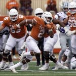 
              Texas running back Roschon Johnson (2) breaks away for a long gain against Kansas State during the second half of an NCAA college football game in Austin, Texas, Friday, Nov. 26, 2021. (AP Photo/Chuck Burton)
            