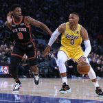 
              Los Angeles Lakers guard Russell Westbrook (0) drives against New York Knicks guard RJ Barrett (9) during the first half of an NBA basketball game Tuesday, Nov. 23, 2021, in New York. (AP Photo/Jim McIsaac)
            