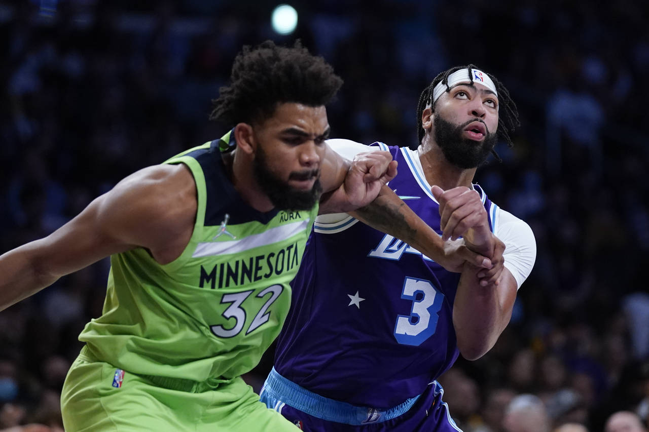 Los Angeles Lakers' Anthony Davis, right, and Minnesota Timberwolves' Karl-Anthony Towns fight for ...