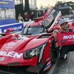 
              Felipe Nasr poses next to the No. 31 Cadillac car after winning the pole for the Petit Le Mans auto race at Road Atlanta, Friday, Nov. 12, 2021, in Braselton, Ga. The Action Express team needs to beat Wayne Taylor Racing in Saturday’s 10-hour race to win the IMSA WeatherTech championship. (AP Photo/Jenna Fryer)
            