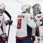 
              Washington Capitals goaltender Ilya Samsonov, right, is congratulated by defenseman Trevor van Riemsdyk (57) and left wing Alex Ovechkin (8) after the Capitals defeated the San Jose Sharks in an NHL hockey game in San Jose, Calif., Saturday, Nov. 20, 2021. (AP Photo/Jeff Chiu)
            