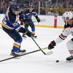 
              St. Louis Blues' Jordan Kyrou, left, shoots past Edmonton Oilers' Darnell Nurse during the second period of an NHL hockey game Sunday, Nov. 14, 2021, in St. Louis. (AP Photo/Jeff Roberson)
            