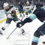 
              Minnesota Wild right wing Ryan Hartman, left, fires the puck past Seattle Kraken right wing Jordan Eberle, right, during the third period of an NHL hockey game Saturday, Nov. 13, 2021, in Seattle. The Wild won 4-2. (AP Photo/Ted S. Warren)
            