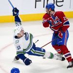 
              Vancouver Canucks' Bo Horvat (53) is topped by Montreal Canadiens defenseman Jeff Petry during the first period of an NHL hockey game, Monday, Nov. 29, 2021 in Montreal. (Paul Chiasson/The Canadian Press via AP)
            