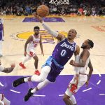 
              Los Angeles Lakers guard Russell Westbrook, second from right, shoots as Chicago Bulls guard Lonzo Ball, left, forward Derrick Jones Jr., right, and guard Coby White, center, defend during the first half of an NBA basketball game Monday, Nov. 15, 2021, in Los Angeles. (AP Photo/Mark J. Terrill)
            