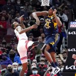 
              Indiana Pacers center Myles Turner, right, blocks a shot by Chicago Bulls forward Derrick Jones Jr. during the first half of an NBA basketball game in Chicago, Monday, Nov. 22, 2021. (AP Photo/Nam Y. Huh)
            