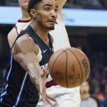 
              Orlando Magic's Gary Harris, front, passes against Cleveland Cavaliers' Lauri Markkanen in the first half of an NBA basketball game, Saturday, Nov. 27, 2021, in Cleveland. (AP Photo/Tony Dejak)
            