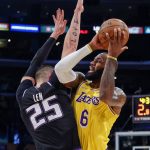 
              Los Angeles Lakers forward LeBron James (6) is defended by Sacramento Kings center Alex Len (25) during the first half of an NBA basketball game in Los Angeles, Friday, Nov. 26, 2021. (AP Photo/Ringo H.W. Chiu)
            