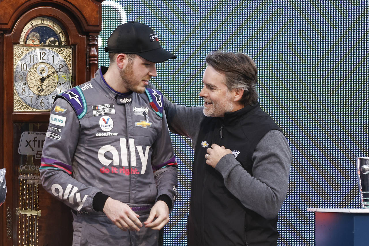 Alex Bowman, left, is congratulated by Jeff Gordon after winning a NASCAR Cup Series auto race, Sun...
