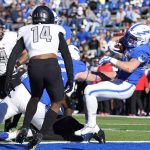 
              Air Force running back Brad Roberts, right, tumbles backward into the end zone for a touchdown past UNLV defensive back Tyson Player in the first half of an NCAA college football game Friday, Nov. 26, 2021, at Air Force Academy, Colo. (AP Photo/David Zalubowski)
            