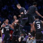 
              Sacramento Kings center Alex Len (25) celebrates with teammates after scoring a 3-pointer against the Los Angeles Lakers during the second half of an NBA basketball game in Los Angeles, Friday, Nov. 26, 2021. The Kings won 141-137 in triple overtime. (AP Photo/Ringo H.W. Chiu)
            
