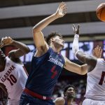
              South Alabama forward Kayo Goncalves (4) fights for a rebound against Alabama center Charles Bediako (10) and guard Keon Ellis (14) during the second half of an NCAA college basketball game, Tuesday, Nov. 16, 2021, in Tuscaloosa, Ala. (AP Photo/Vasha Hunt)
            